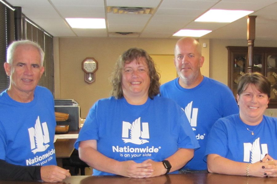 About Our Agency - Portrait of Sheward Fulks Agency Staff Standing in the Office Wearing Nationwide Shirts